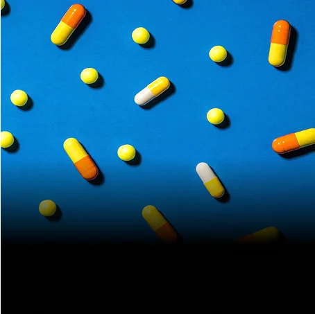 pills pattern over a blue top
