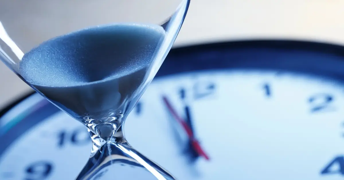 stylized photo of an hourglass with a clock